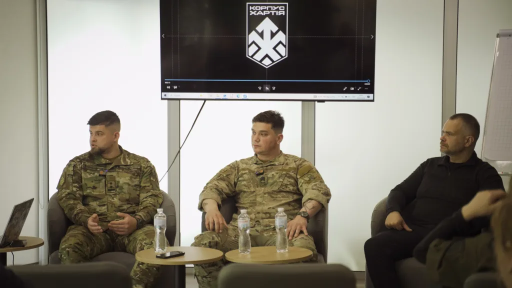 Обговорення військових у формі перед екраном