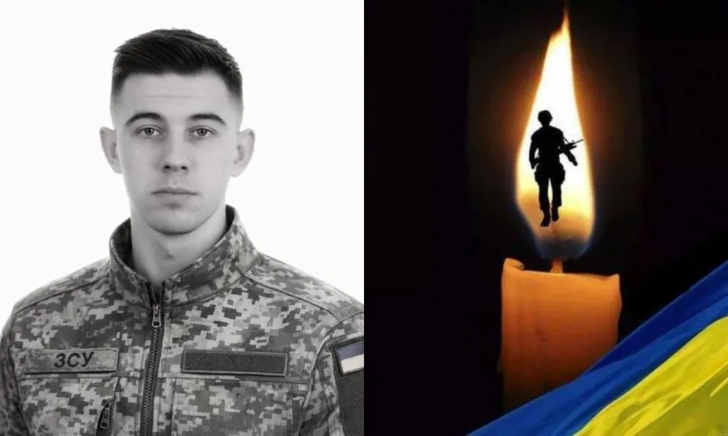 Український військовий та свічка пам’яті з прапором