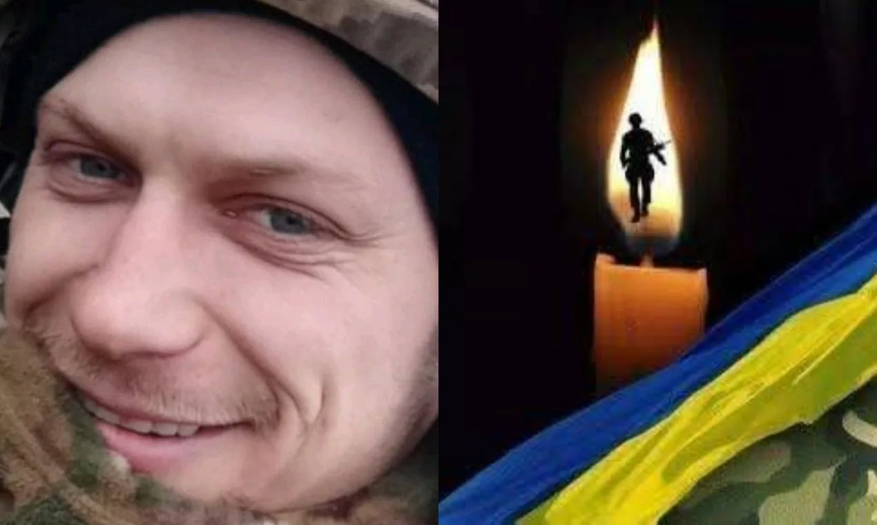 Український військовий і свічка пам’яті з прапором