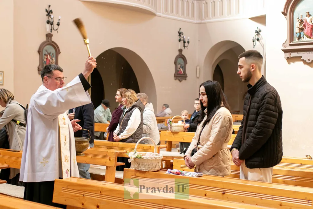 Священник освячує великодні кошики у церкві