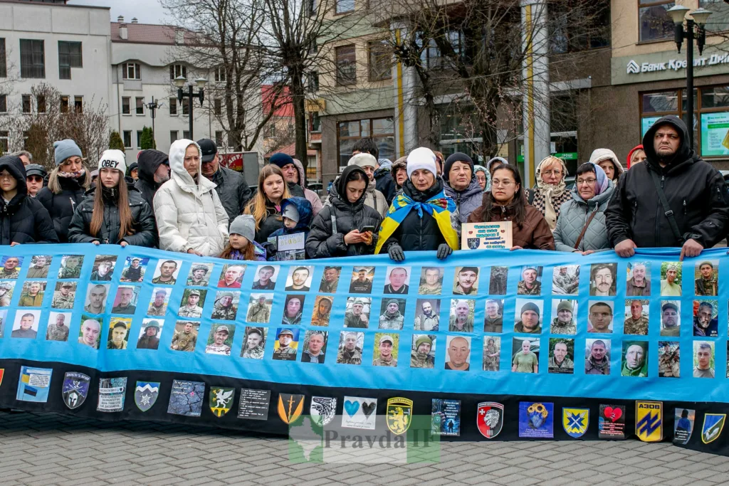 Мітинг на честь українських захисників із банером фотографій