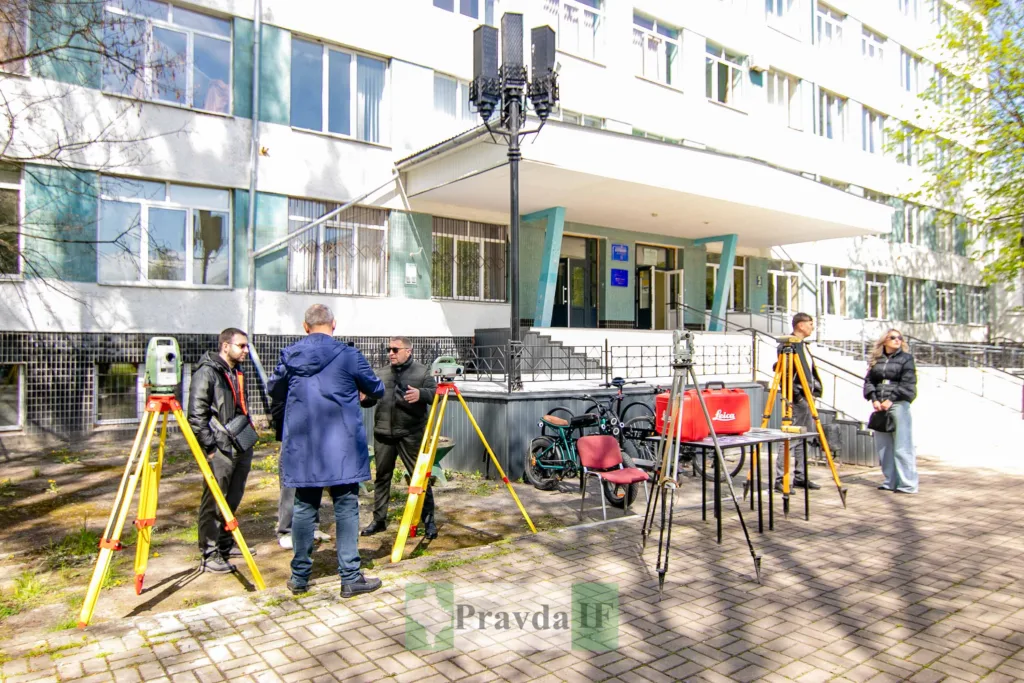 Студенти вивчають геодезичне обладнання перед будівлею університету