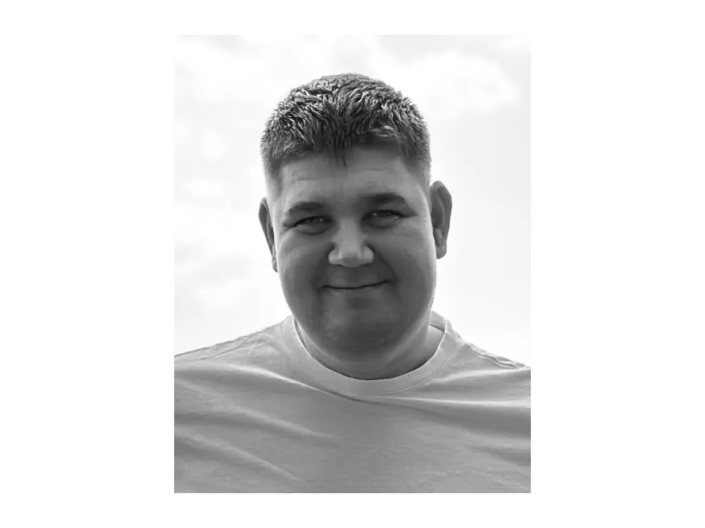 Чоловік усміхається на чорно-білому фото