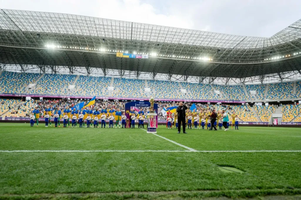 Футбольний стадіон з українськими прапорами та кубком