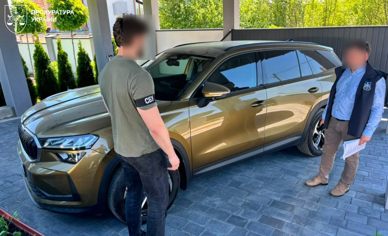 Співробітники СБУ біля бронзового автомобіля