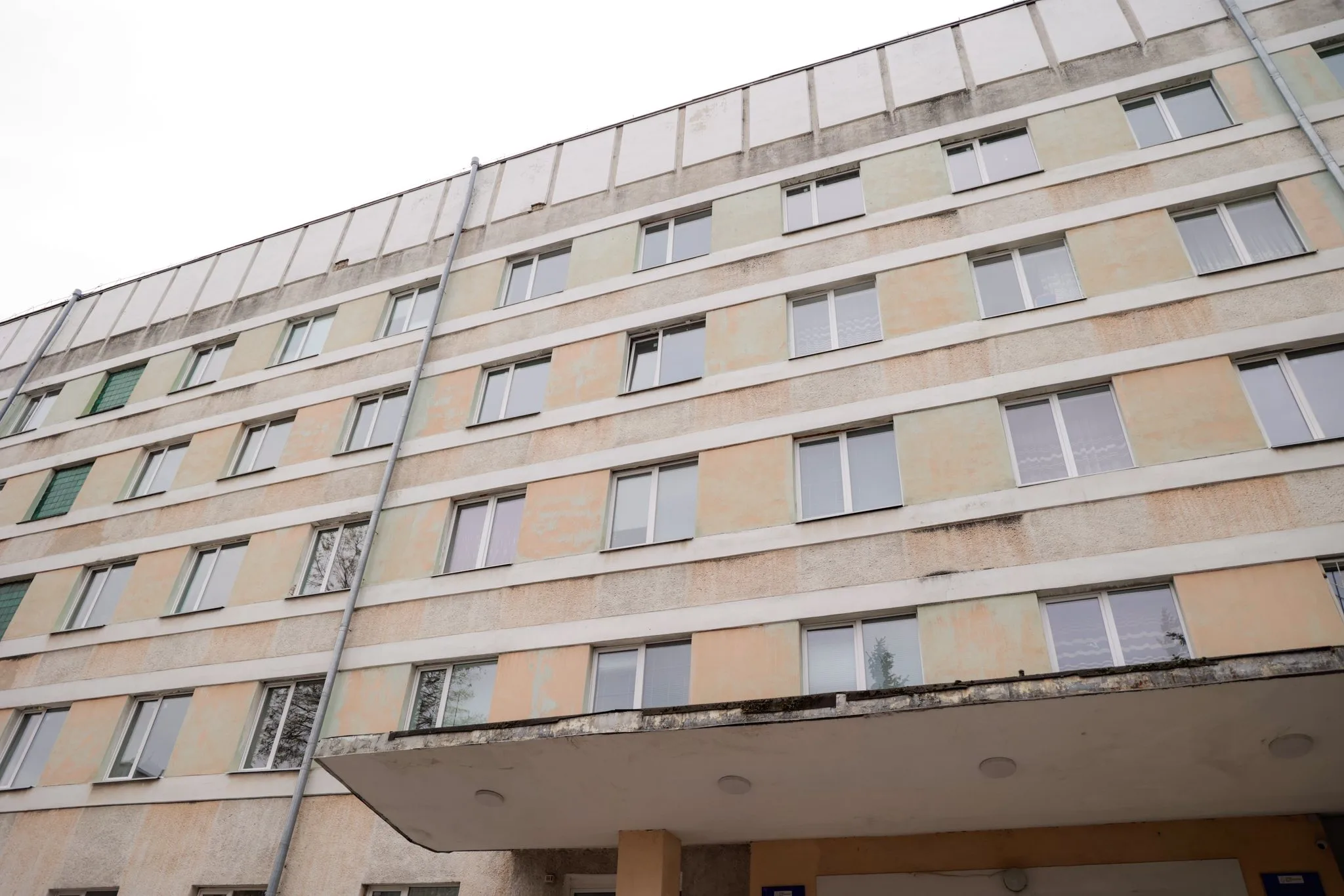 Старий п'ятиповерховий житловий будинок з вікнами