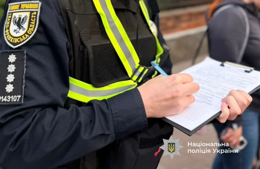 Поліцейський заповнює протокол на вулиці