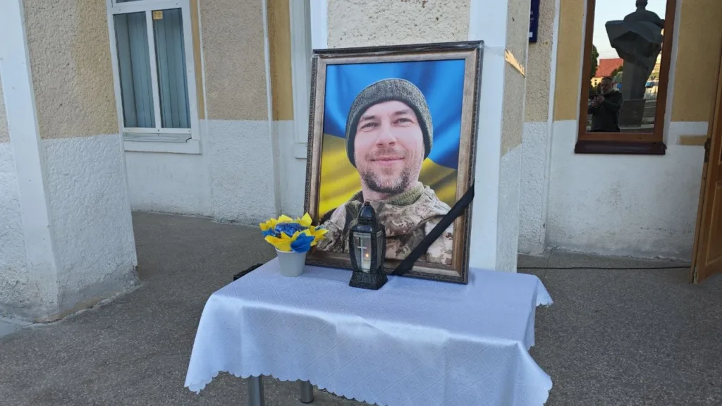 Портрет військового з прапором України на столі