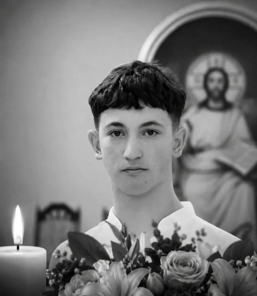 Юнак із квітами та запаленою свічкою у церкві