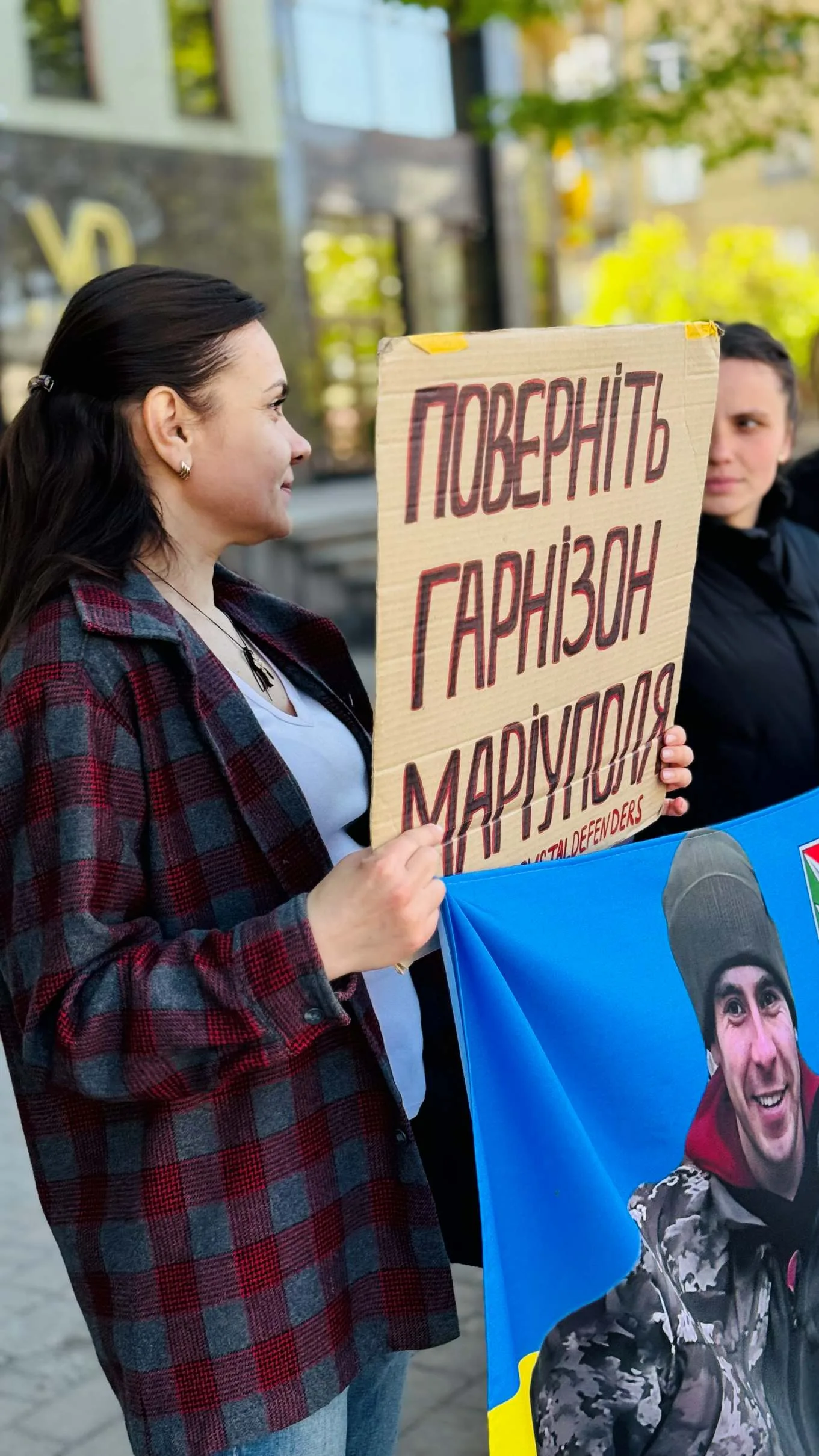 Жінки тримають плакат підтримки захисників Маріуполя