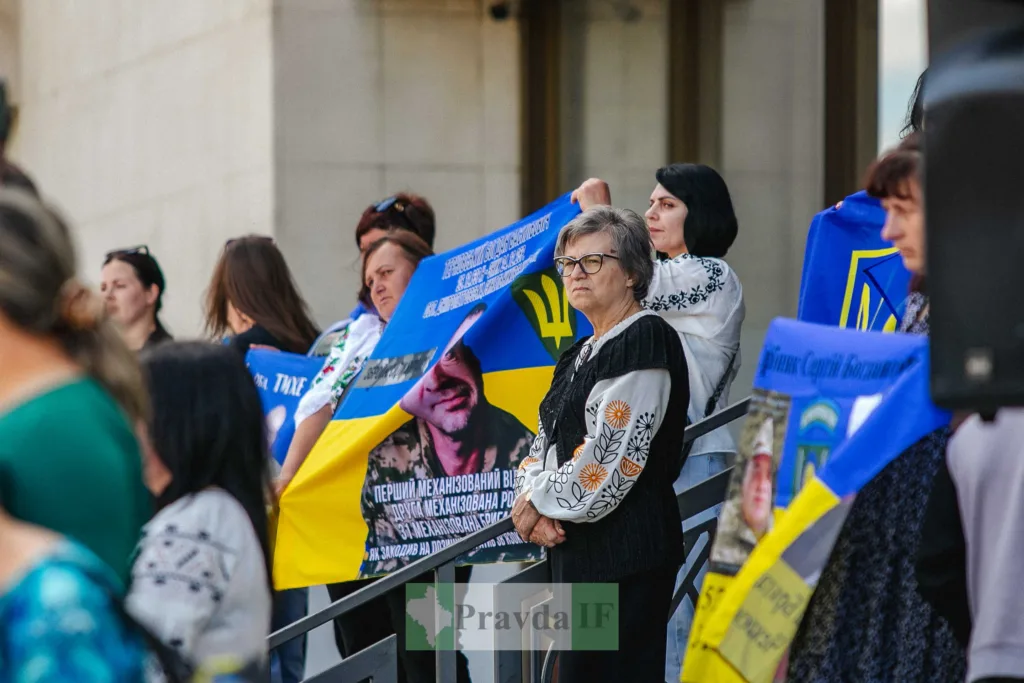 Жінки тримають українські прапори на демонстрації
