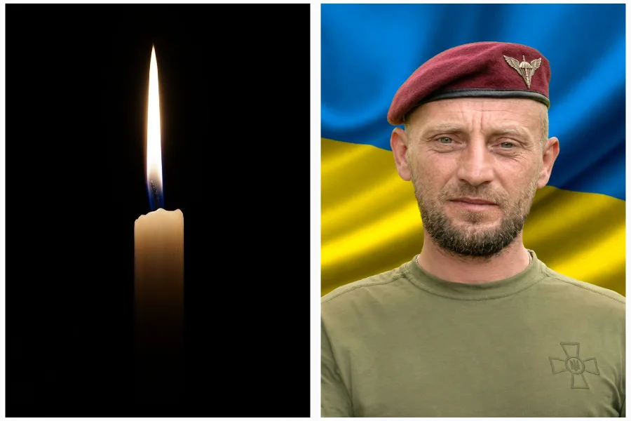 Свічка пам’яті та український військовий на фоні прапора