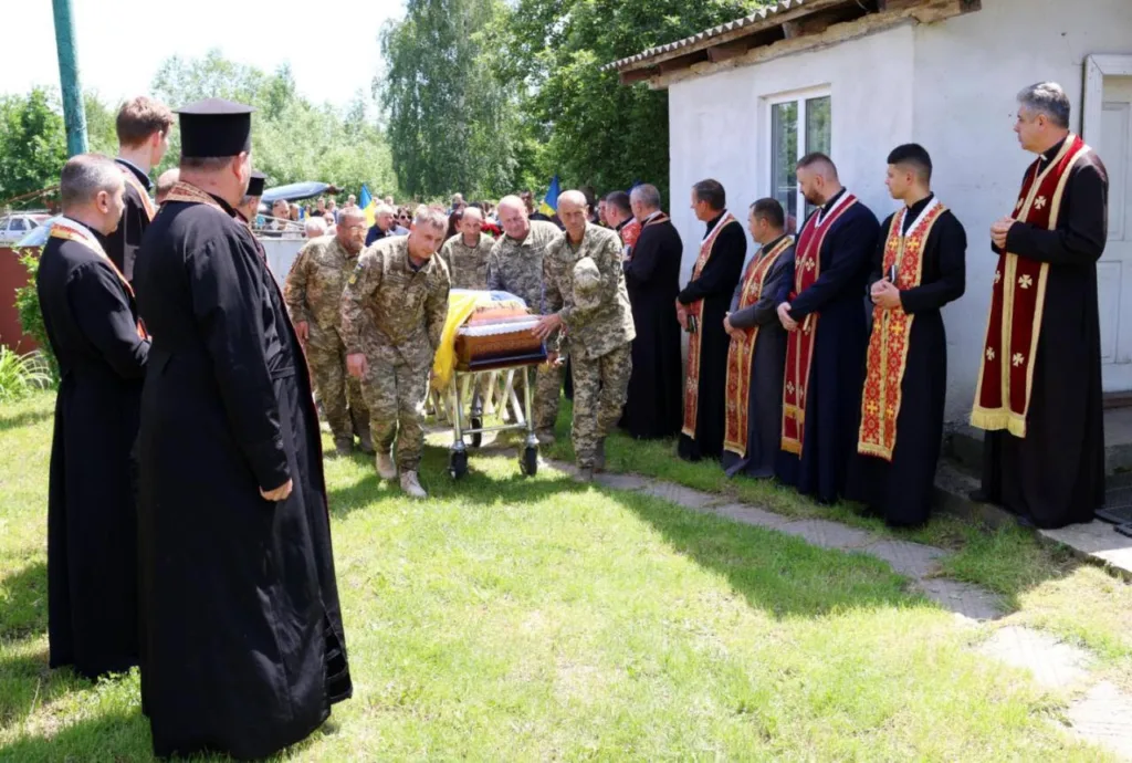 Військові несуть труну під час похорону героя