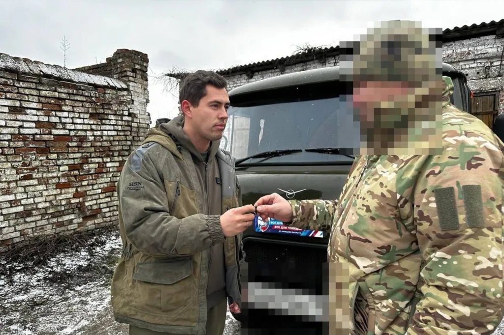Військові обмінюються предметом біля вантажівки