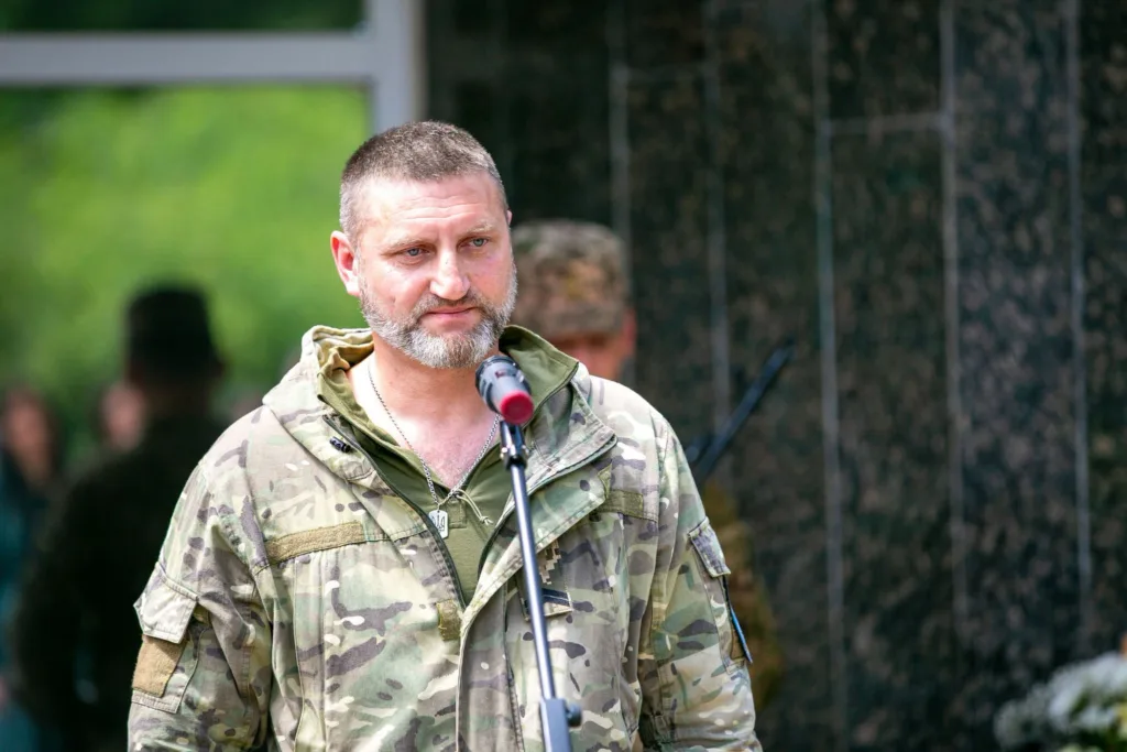 Військовий у камуфляжі говорить біля мікрофона