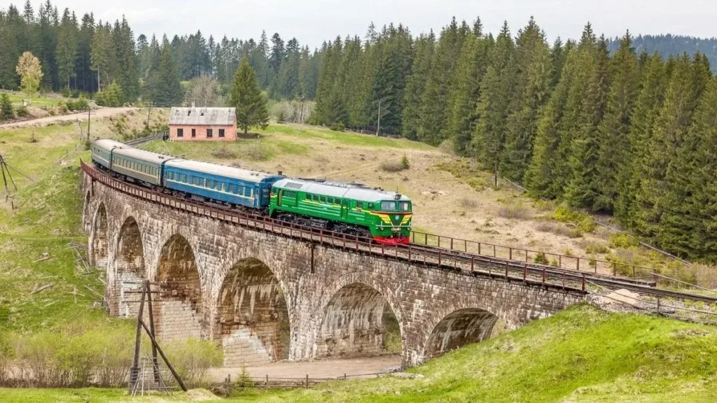 Потяг на кам'яному віадуку серед гір