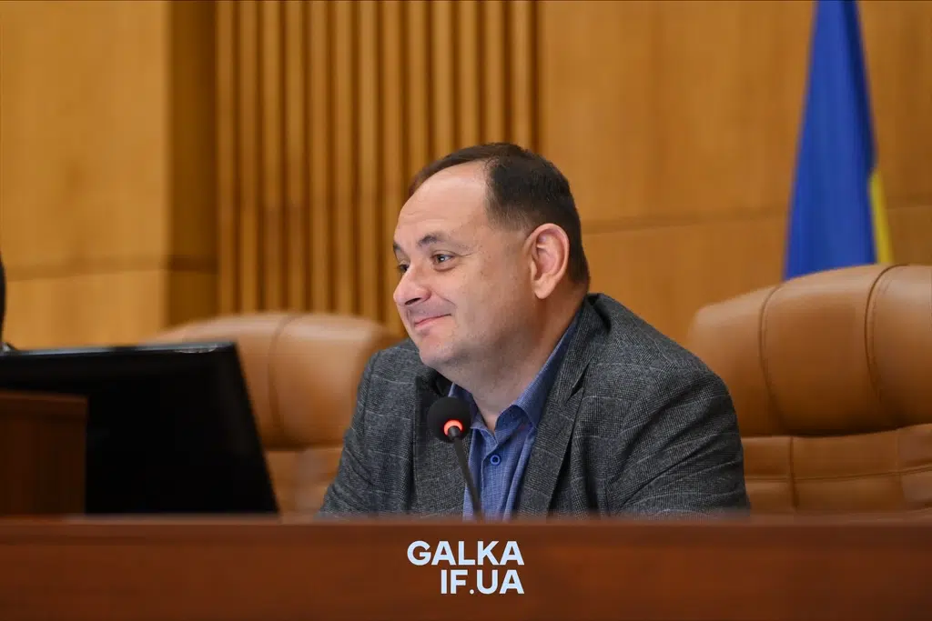 Чоловік виступає на засіданні ради