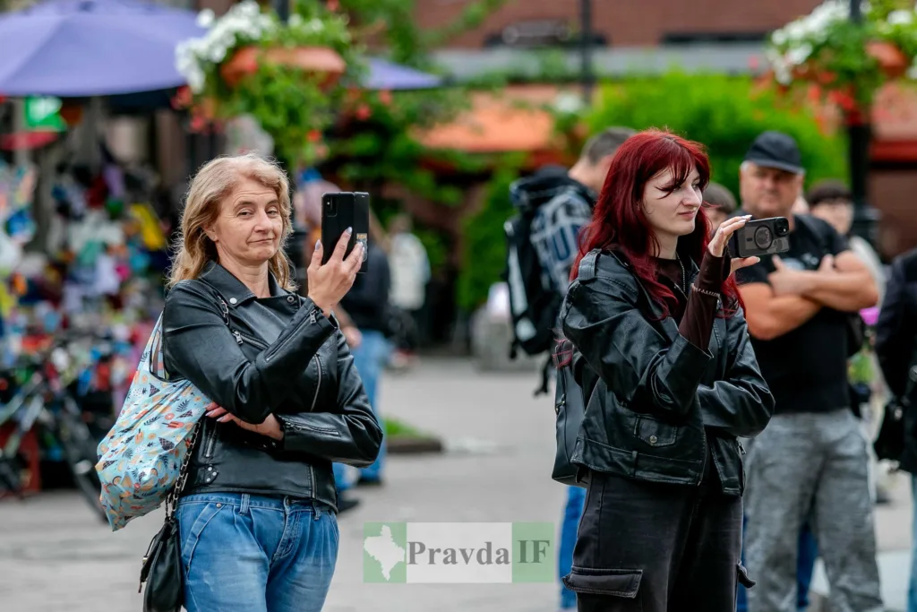 Жінки фотографують подію на вулиці