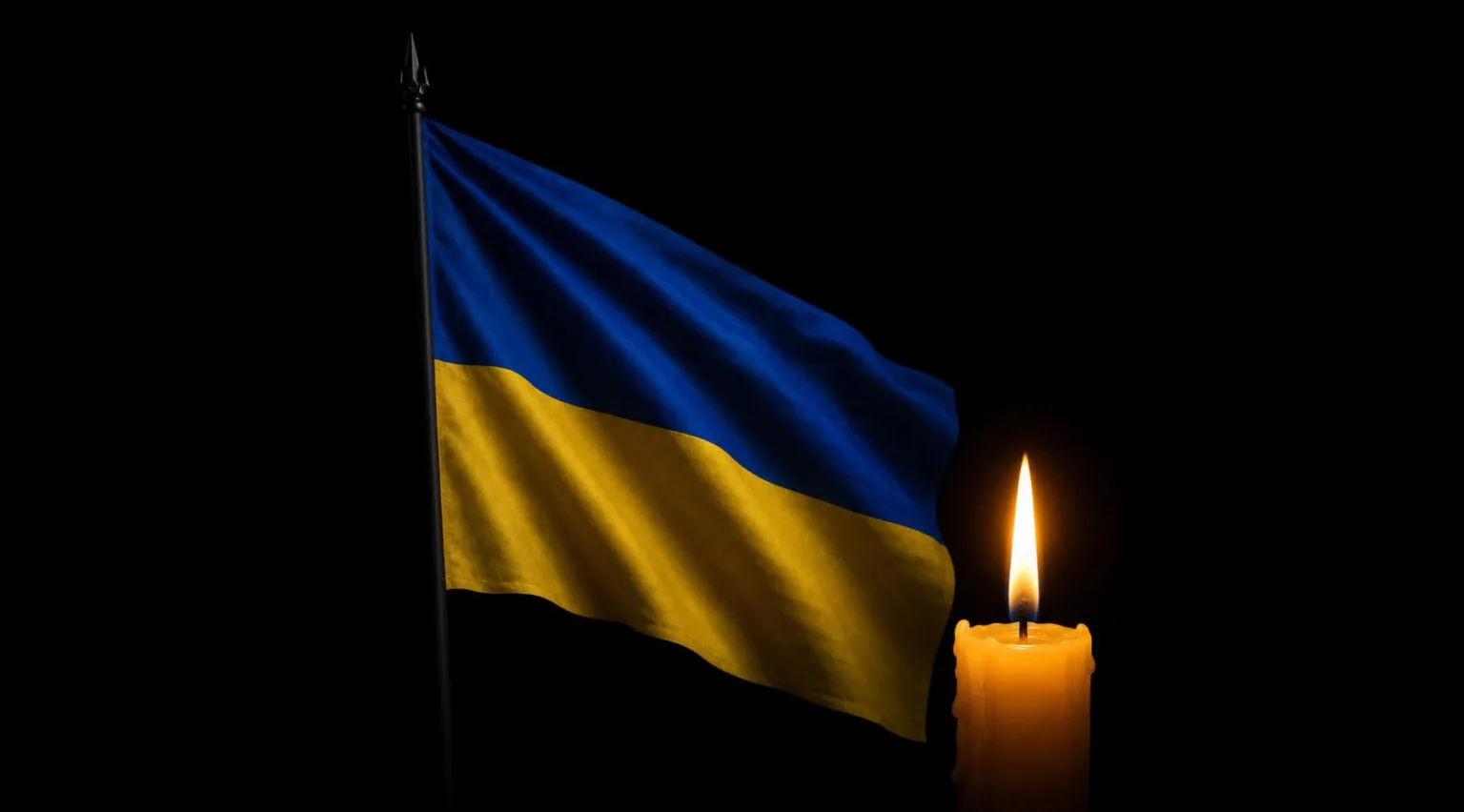 Прапор України та палаюча свічка на чорному тлі