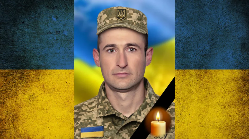 Український військовий на тлі прапора України