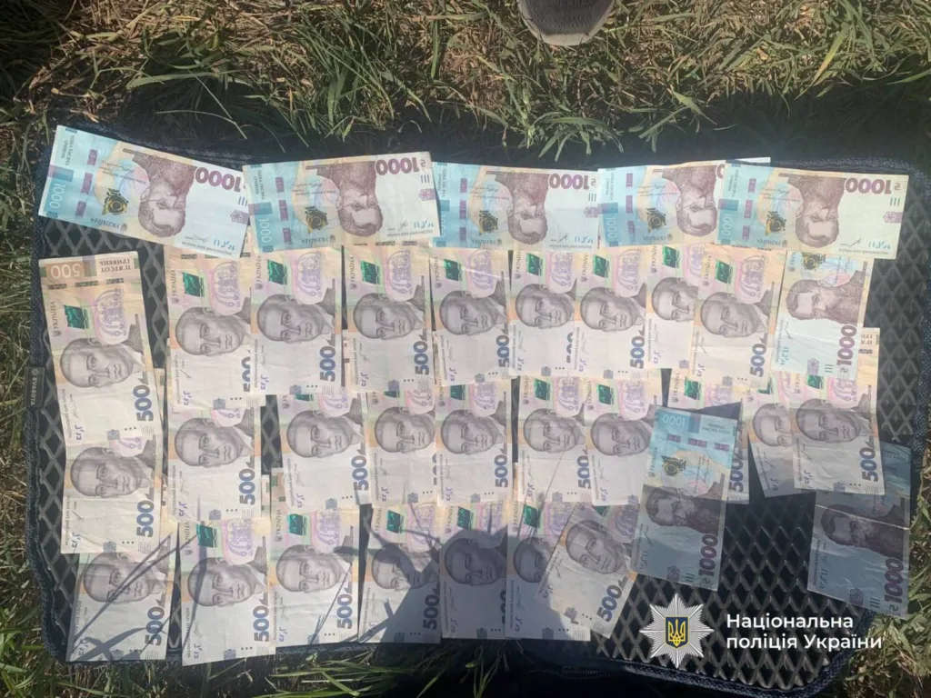 Українські гривні на поверхні, фото поліції України