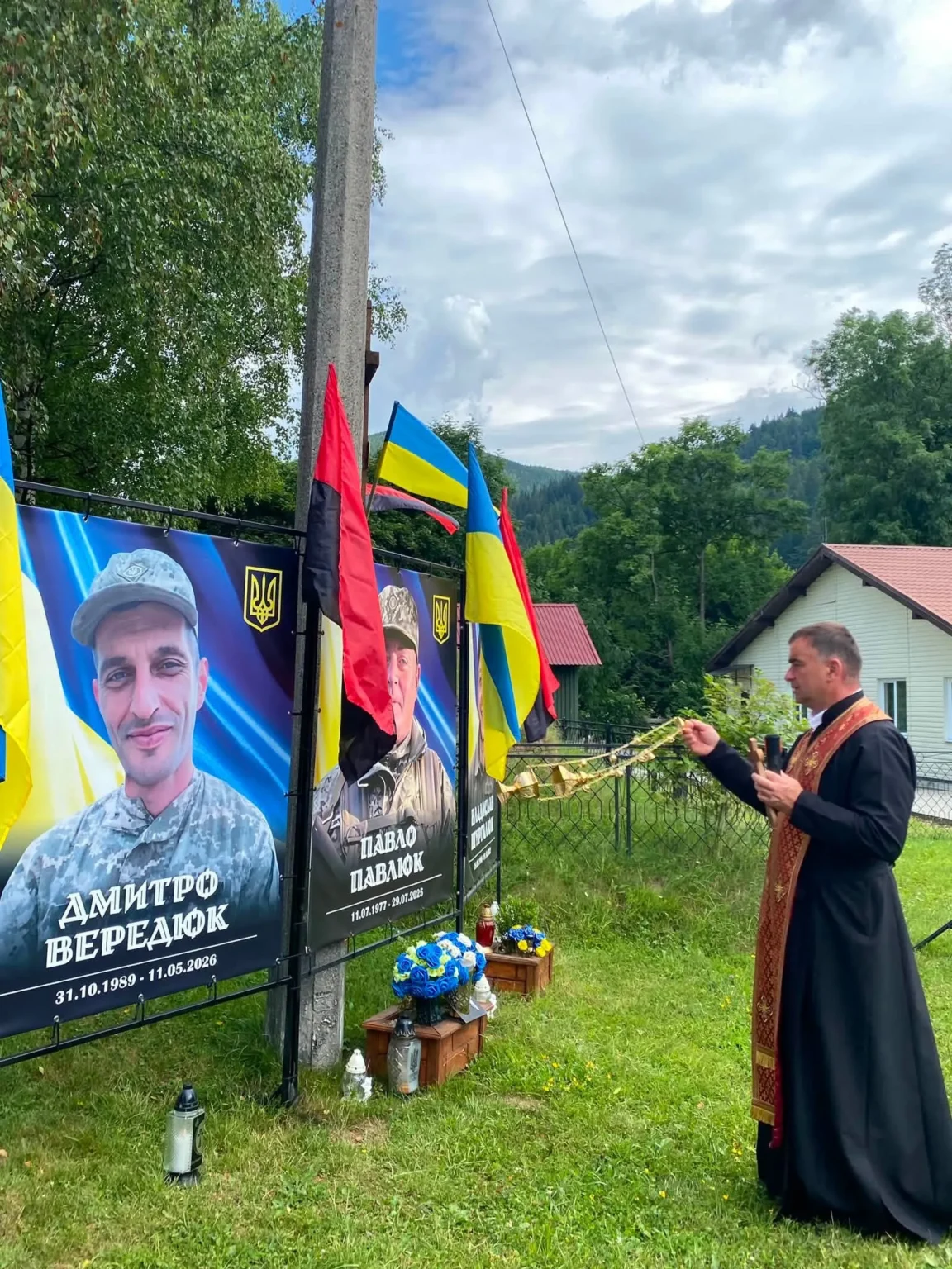 Священник освячує меморіал полеглим українським воїнам