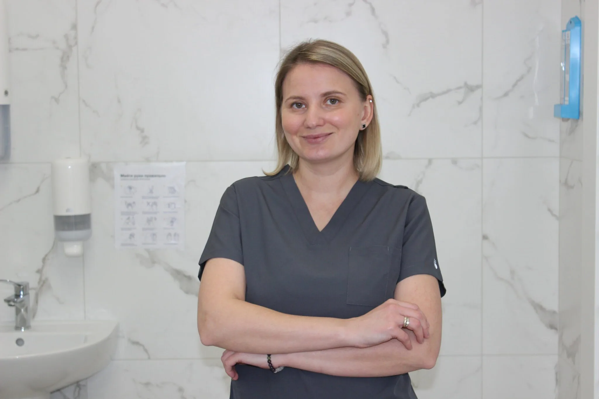 Медичний працівник у сірій формі в клініці