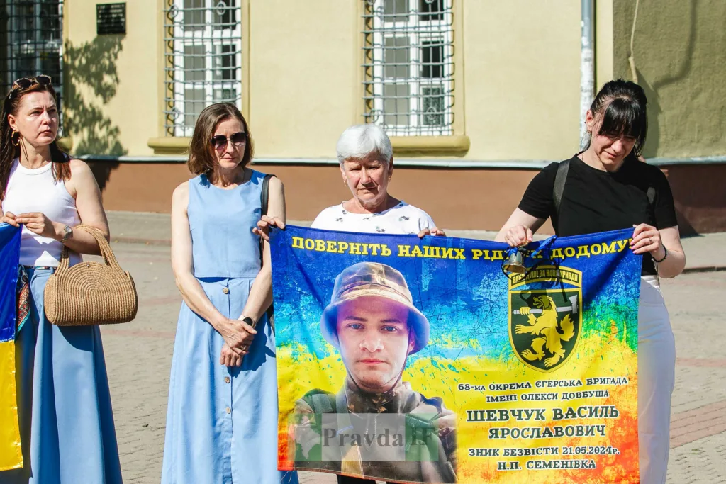 Жінки тримають плакат із фотографією зниклого військового