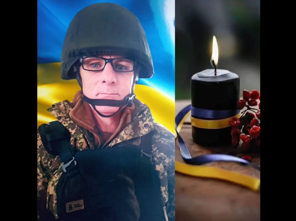 Український військовий і свічка пам’яті з прапором