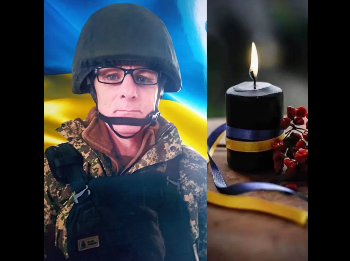 Український військовий і свічка пам’яті з прапором