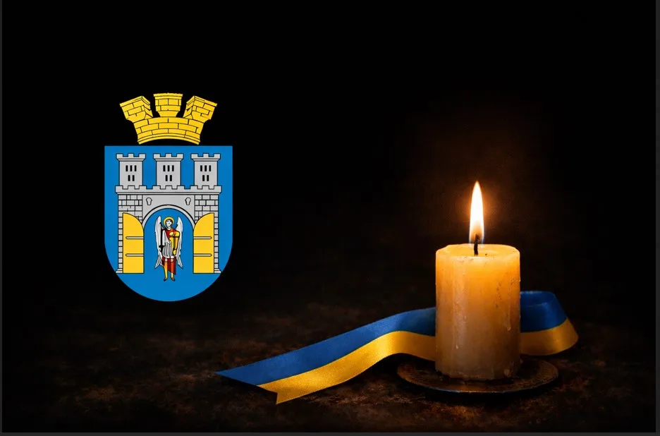 Запалена свічка, українська стрічка та герб Києва