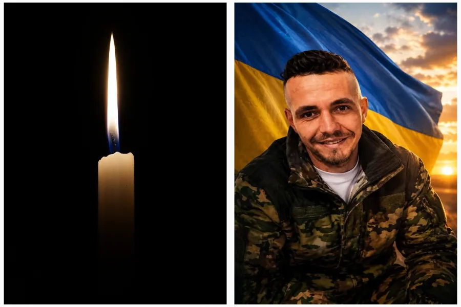 Запалена свічка поруч із військовим на тлі прапора України