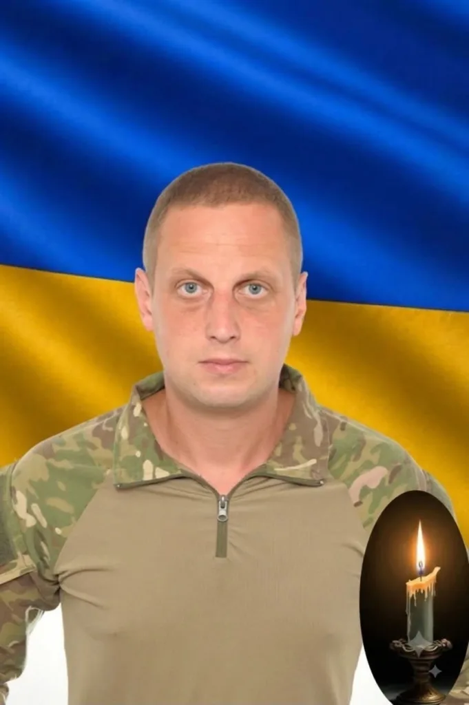 Військовий портрет на тлі українського прапора зі свічкою