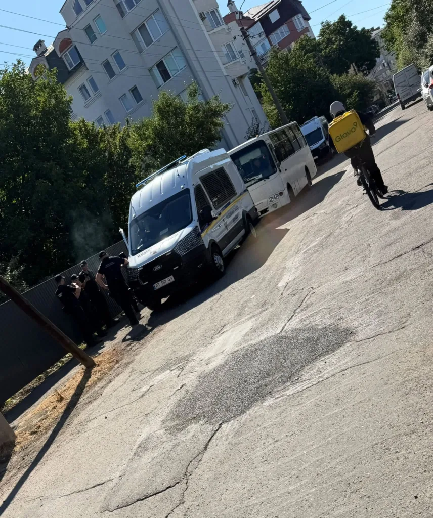 Поліцейський фургон, автобус і кур’єр Glovo на вулиці