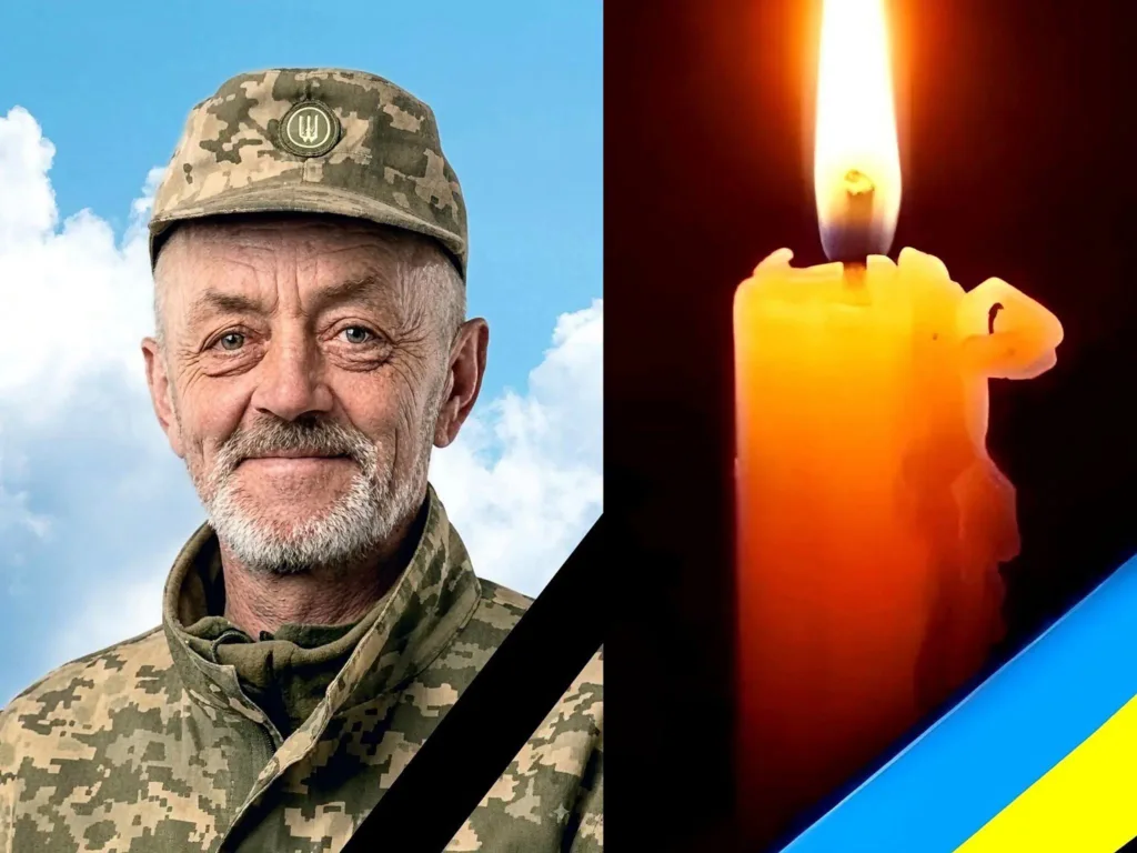 Портрет українського військового, свічка та прапор у жалобі