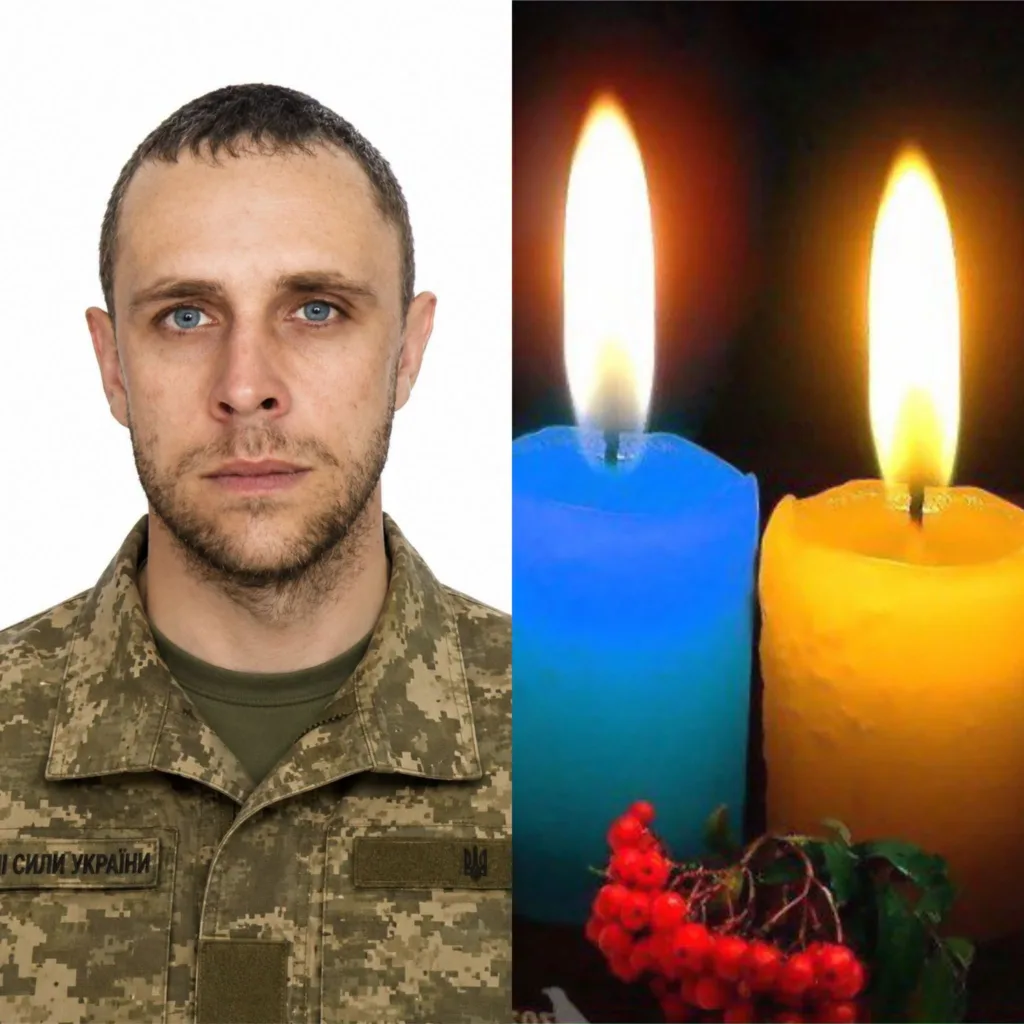Портрет українського військового поруч із синьо-жовтими свічками