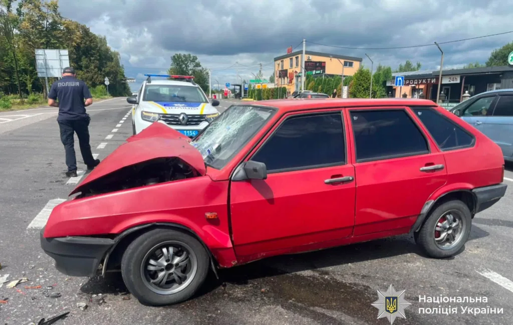 Пошкоджений червоний автомобіль біля патрульної поліції