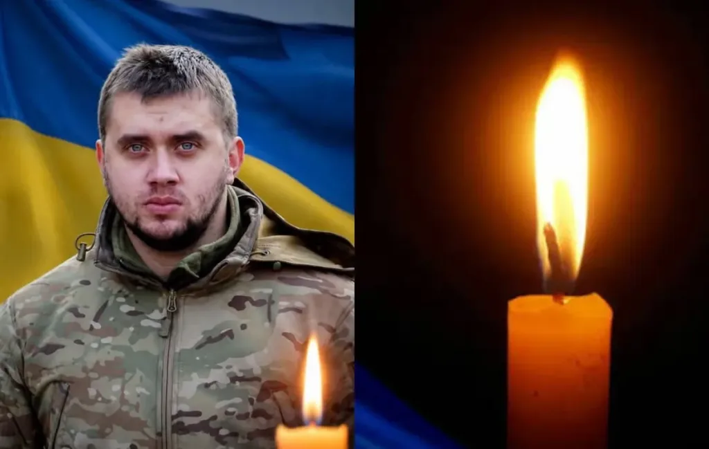 Український військовий на тлі прапора і запаленої свічки