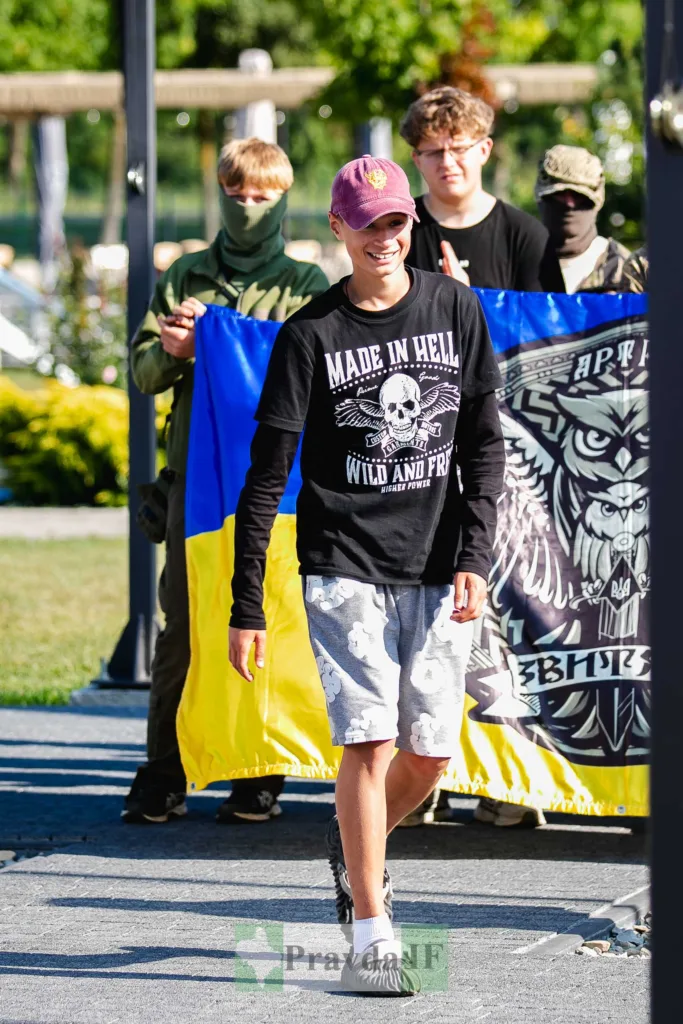 Юнак і люди з українським прапором на вулиці