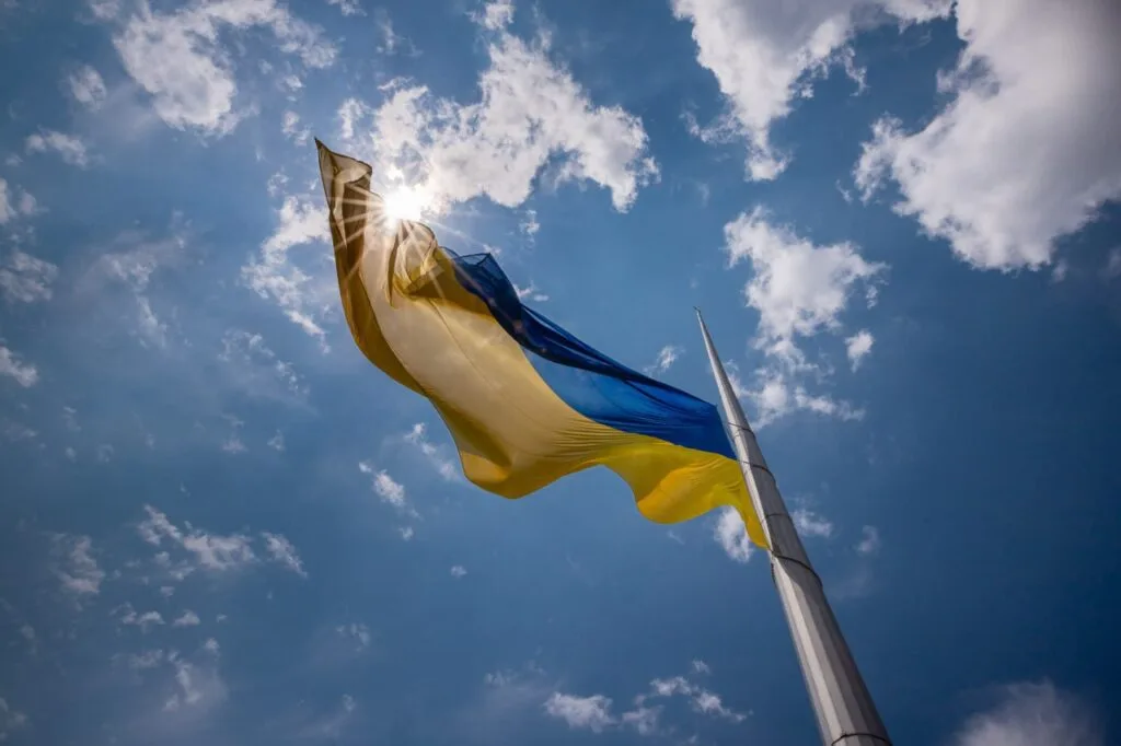 Український прапор майорить на тлі сонячного неба