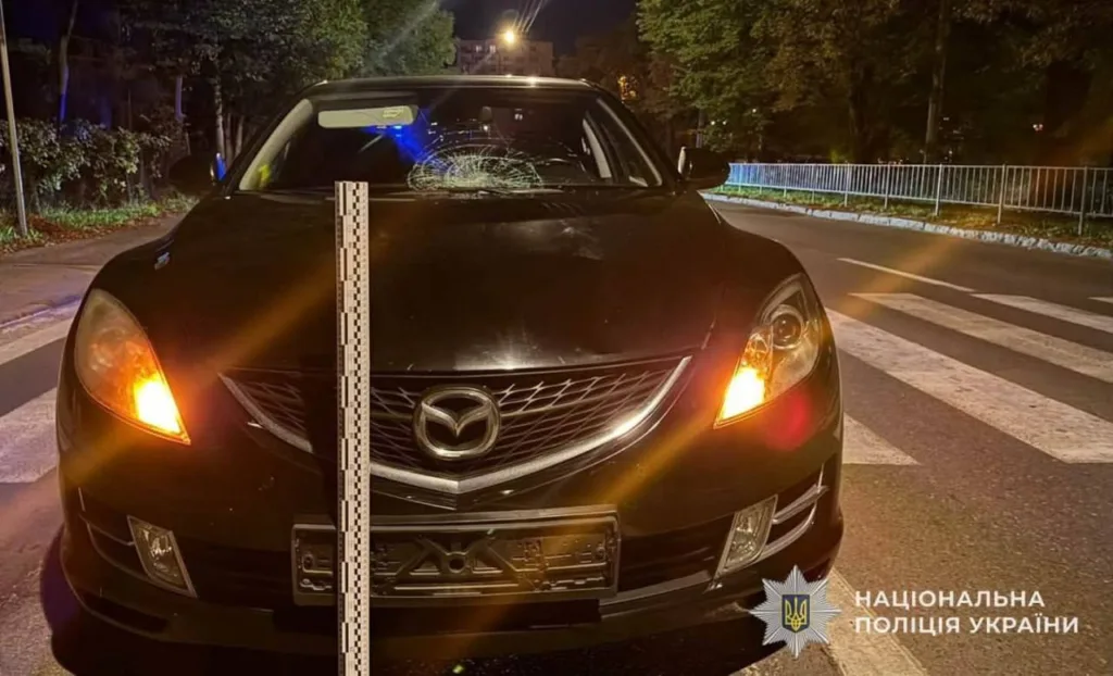 Чорна Mazda з розбитим лобовим склом уночі