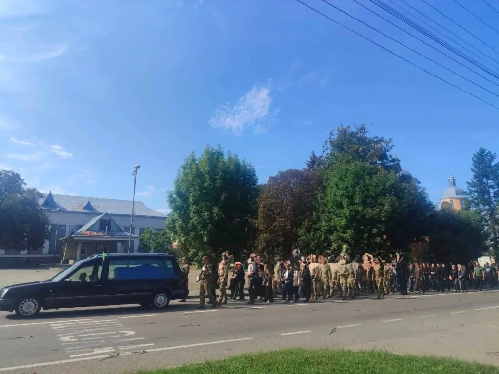 Траурна процесія з військовими біля чорного катафалка