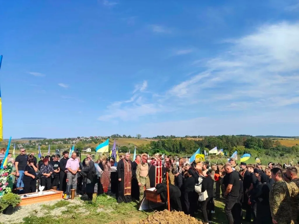 Похорон військових із українськими прапорами на кладовищі