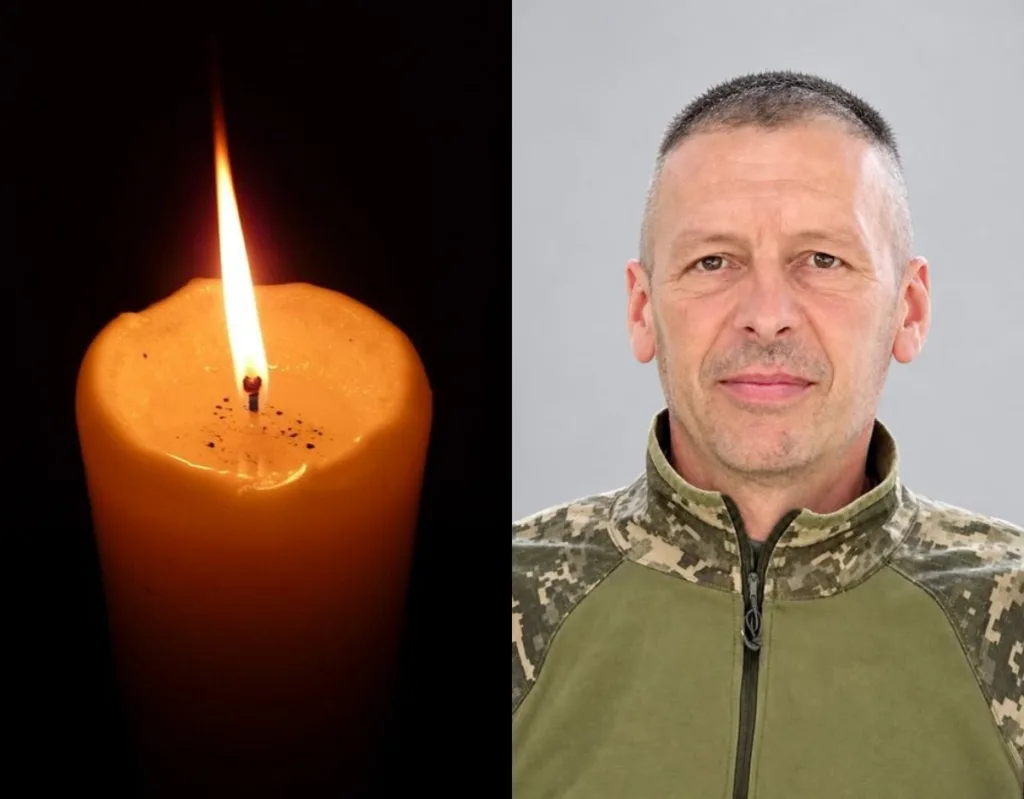 Запалена свічка поруч із портретом військовослужбовця