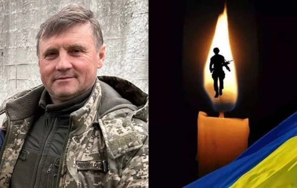Портрет військового поруч зі свічкою та українським прапором