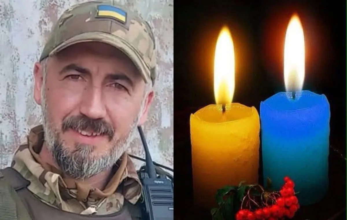 Портрет українського військового поруч із запаленими свічками