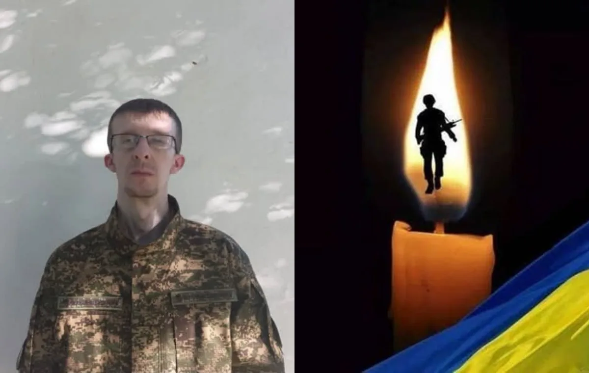 Портрет військового поруч зі свічкою та українським прапором