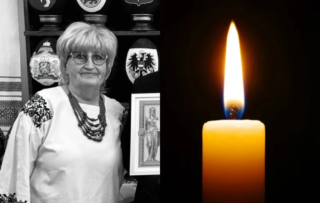 Портрет жінки у вишиванці поруч із запаленою свічкою