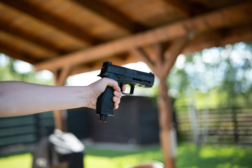 unrecognizable,woman,holding,and,aiming,a,black,air,bb,gun.